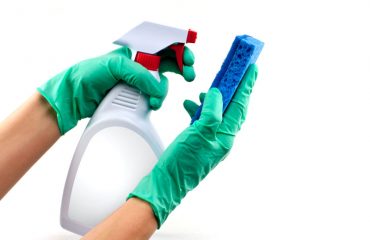 Spraying a cleaning product onto a sponge