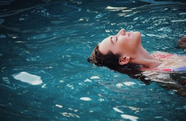 Woman floating in a swim spa.
